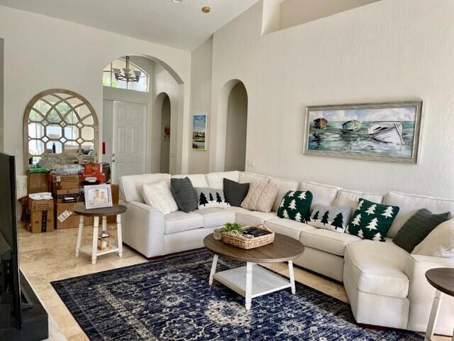 living room featuring a towering ceiling