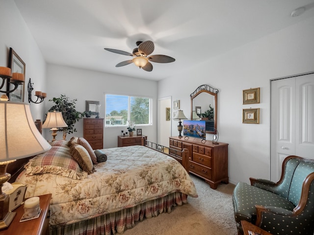 carpeted bedroom with a closet and ceiling fan