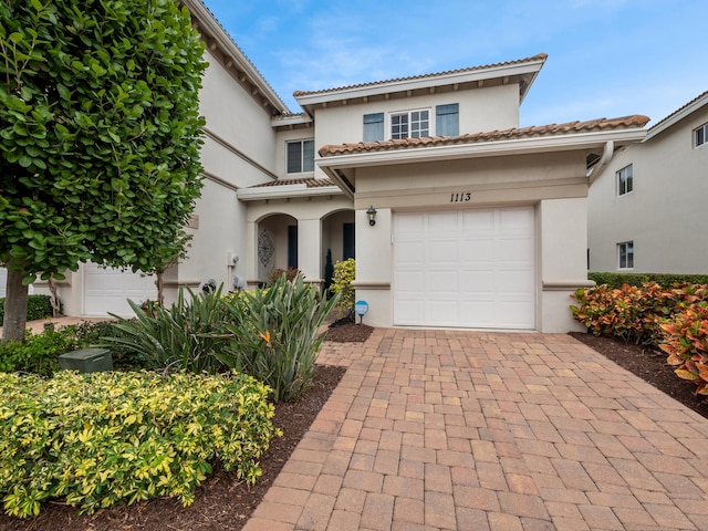 mediterranean / spanish-style house featuring a garage