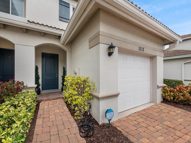 doorway to property featuring a garage