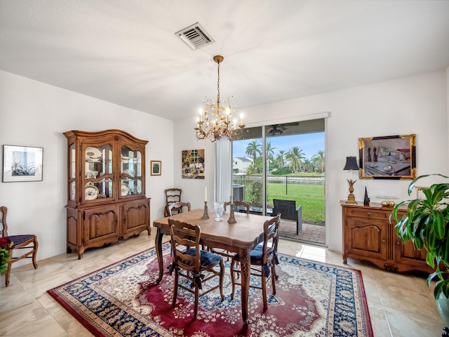 tiled dining area with a chandelier