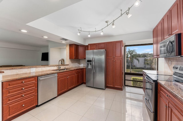 kitchen featuring tasteful backsplash, sink, stainless steel appliances, light stone counters, and light tile patterned flooring