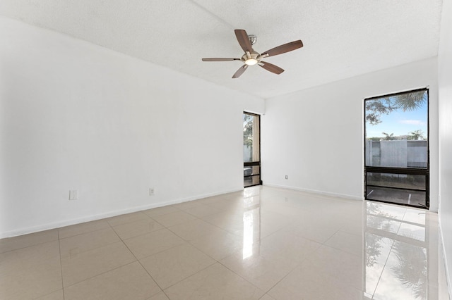 tiled spare room featuring ceiling fan and a textured ceiling