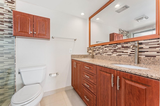 bathroom with decorative backsplash, tile patterned floors, toilet, and vanity