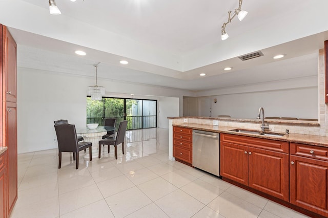 kitchen featuring pendant lighting, sink, light tile patterned flooring, light stone counters, and stainless steel dishwasher