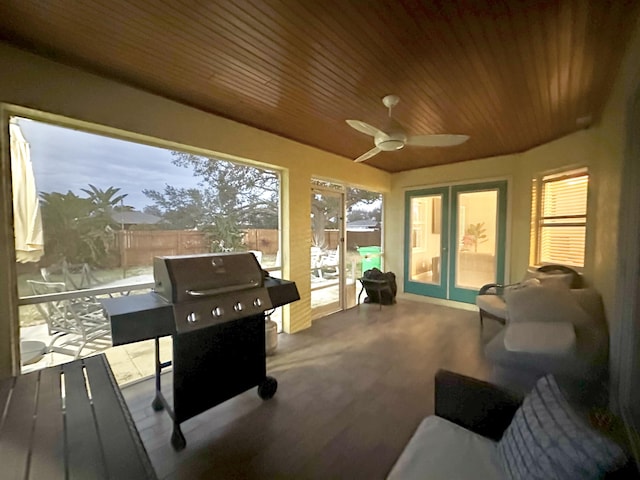 sunroom with ceiling fan and french doors