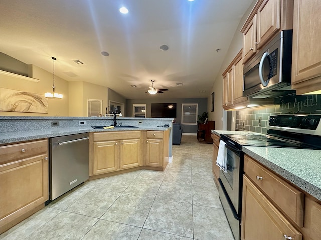 kitchen featuring stainless steel appliances, tasteful backsplash, sink, hanging light fixtures, and light tile patterned flooring