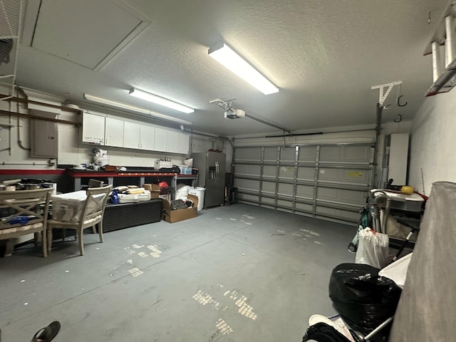 garage featuring stainless steel fridge and a garage door opener