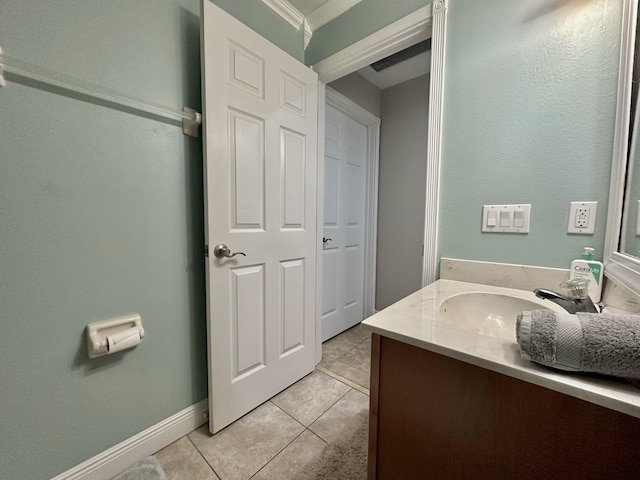 bathroom with crown molding, tile patterned floors, and vanity