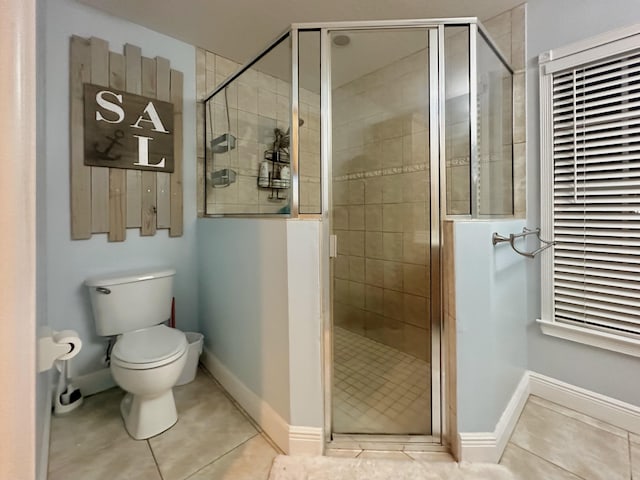 bathroom with toilet, tile patterned flooring, and a shower with door