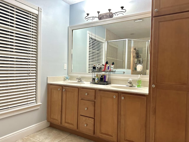 bathroom featuring tile patterned floors, an enclosed shower, and vanity