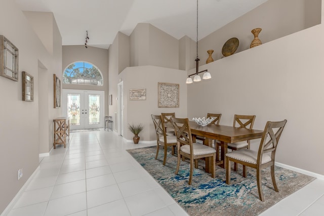 1401 SE Glencoe Ct, Port Saint Lucie, FL 34952 - dining space featuring light tile patterned floors, high vaulted ceiling, baseboards, and french doors