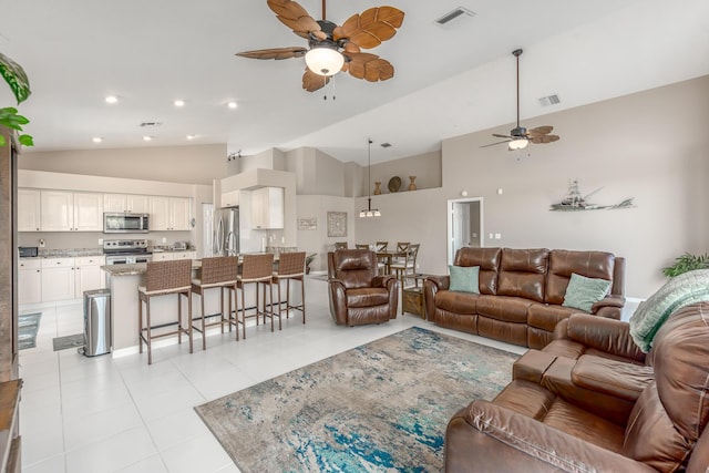1401 SE Glencoe Ct, Port Saint Lucie, FL 34952 - living room featuring high vaulted ceiling, a ceiling fan, light tile patterned flooring, and visible vents