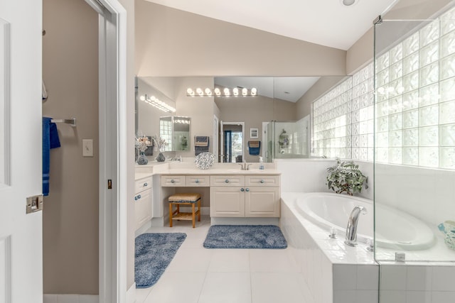 1401 SE Glencoe Ct, Port Saint Lucie, FL 34952 - full bathroom with a walk in shower, tile patterned flooring, vanity, lofted ceiling, and a garden tub