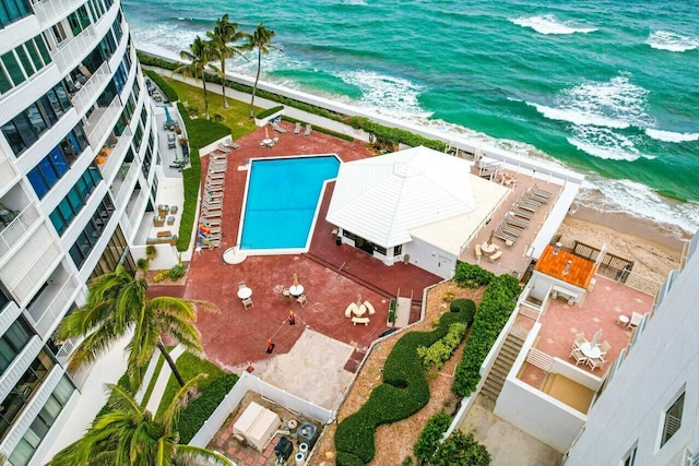 bird's eye view featuring a water view and a beach view