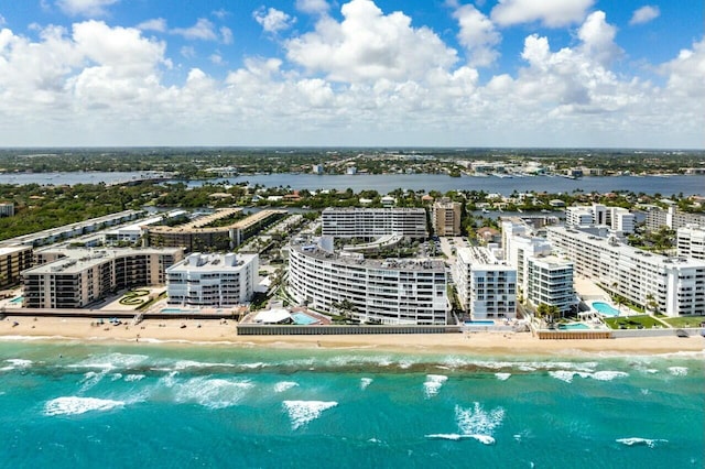 birds eye view of property with a water view and a view of the beach