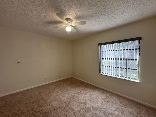 carpeted empty room featuring a textured ceiling and ceiling fan