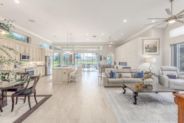 living room featuring ornamental molding and ceiling fan