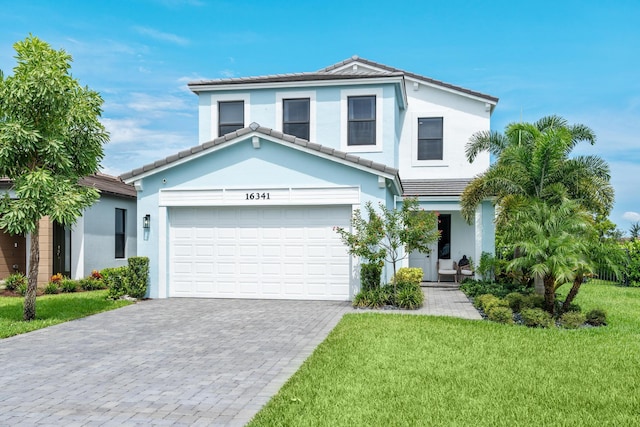 view of front of home with a garage and a front lawn