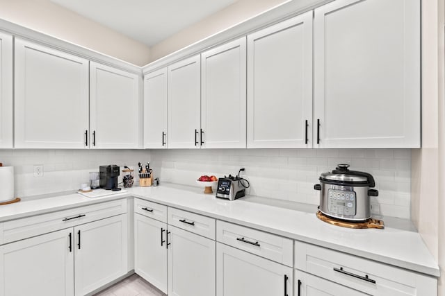 kitchen with white cabinetry and tasteful backsplash