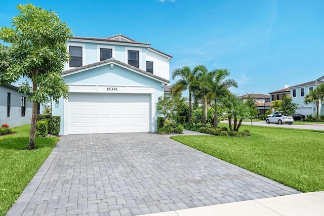 view of front of home with a front lawn and a garage