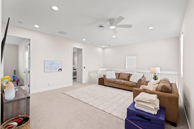 carpeted living room featuring ceiling fan