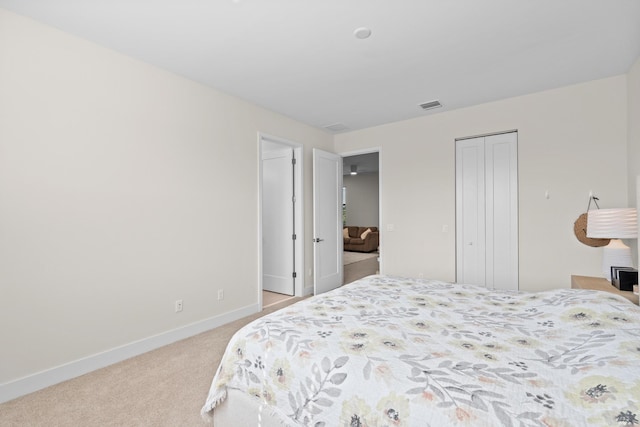 bedroom with light colored carpet and a closet