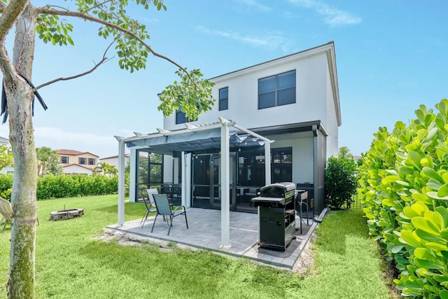 back of property with a lawn, a pergola, and a patio area