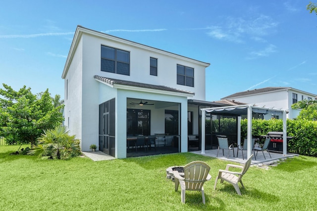 rear view of house featuring a pergola, a patio area, a sunroom, and a yard