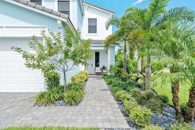 view of exterior entry with a garage