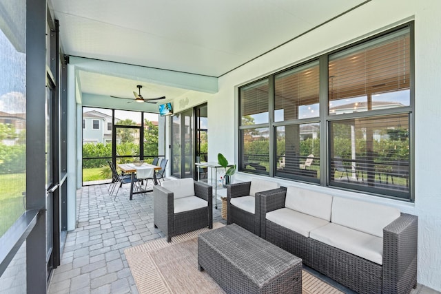 sunroom featuring ceiling fan