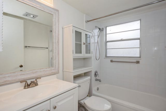 full bathroom with toilet, vanity, and tiled shower / bath