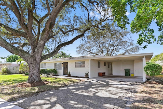 ranch-style house featuring a carport