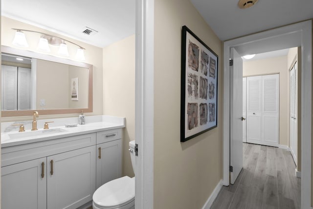 bathroom featuring hardwood / wood-style floors, toilet, and vanity