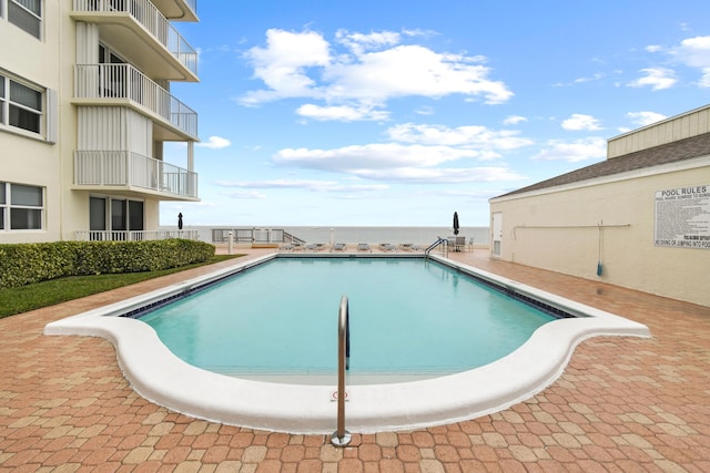 view of swimming pool with a water view