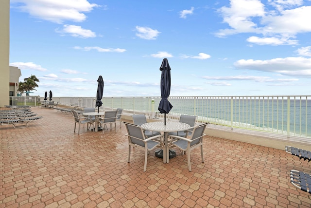 view of patio / terrace featuring a water view and a view of the beach