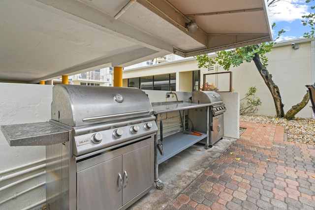 view of patio with a grill and an outdoor kitchen