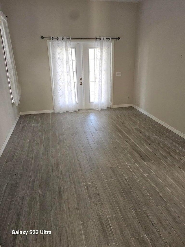 unfurnished room featuring french doors and dark hardwood / wood-style floors