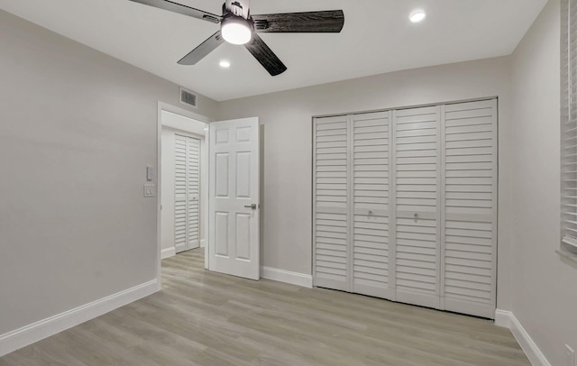 unfurnished bedroom with ceiling fan, light hardwood / wood-style floors, and a closet