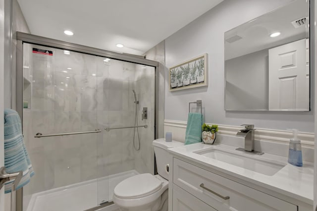 bathroom with vanity, an enclosed shower, and toilet