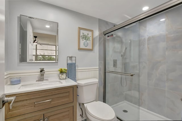 bathroom featuring vanity, an enclosed shower, ceiling fan, and toilet