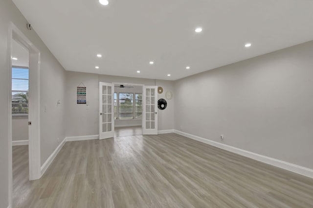 unfurnished living room featuring french doors and light hardwood / wood-style floors