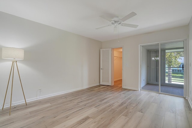 empty room featuring ceiling fan and light wood-type flooring