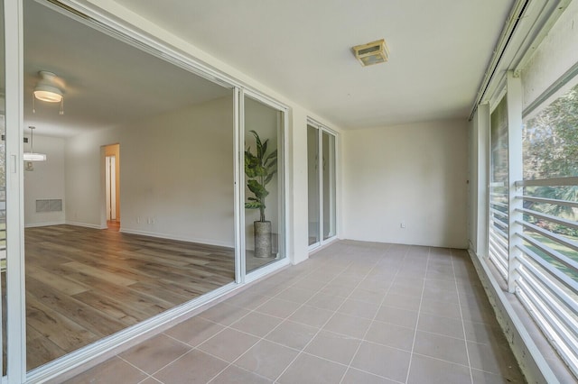 unfurnished sunroom with a wealth of natural light