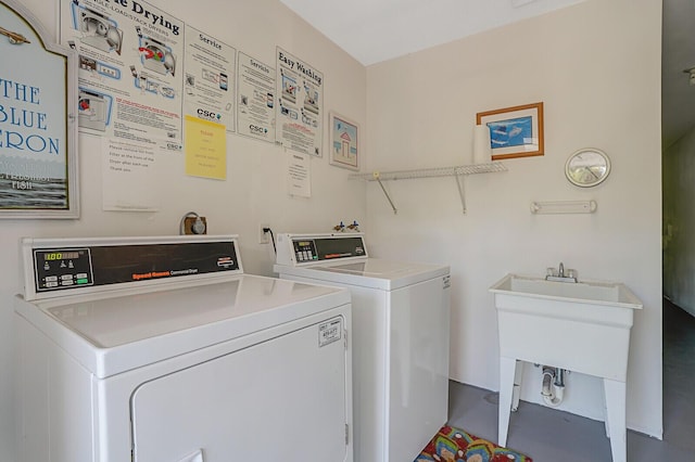 clothes washing area with sink and washer and dryer