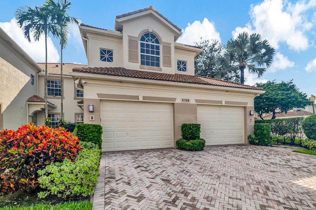 mediterranean / spanish-style home with a garage