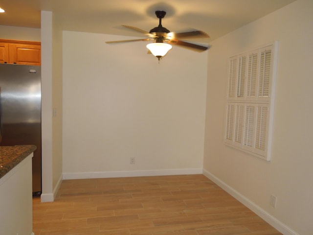 spare room with ceiling fan and light hardwood / wood-style flooring