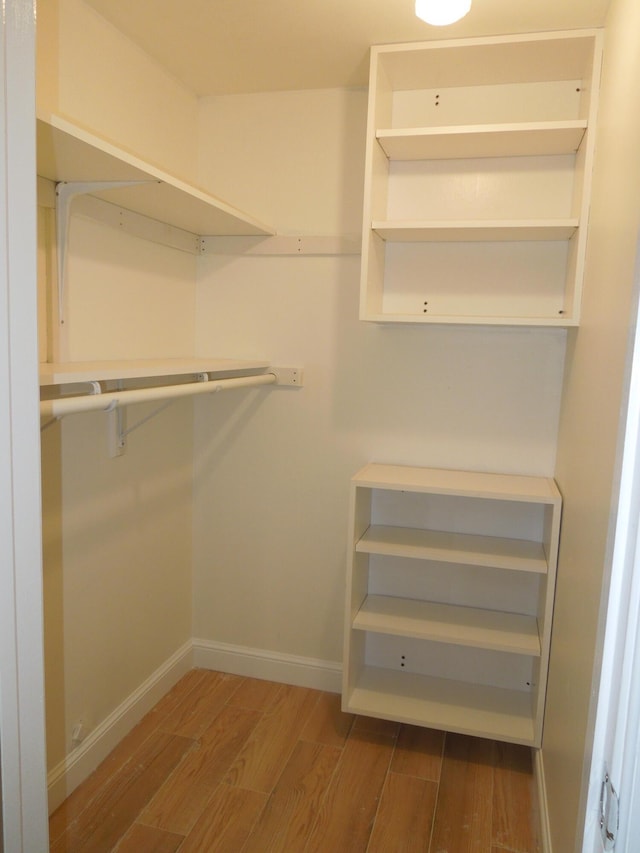 spacious closet featuring hardwood / wood-style floors