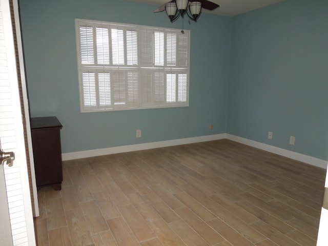 unfurnished room featuring light wood-type flooring and ceiling fan