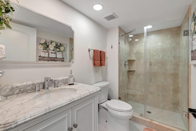 bathroom featuring vanity, toilet, and walk in shower